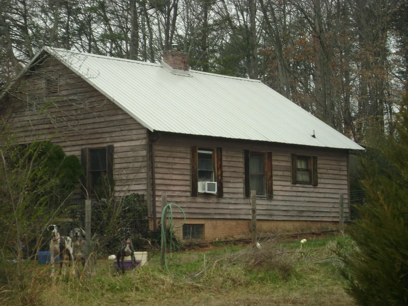 White metal roof on an old wood sided farmhouse, from a Metal Roof Installation job in Terreton