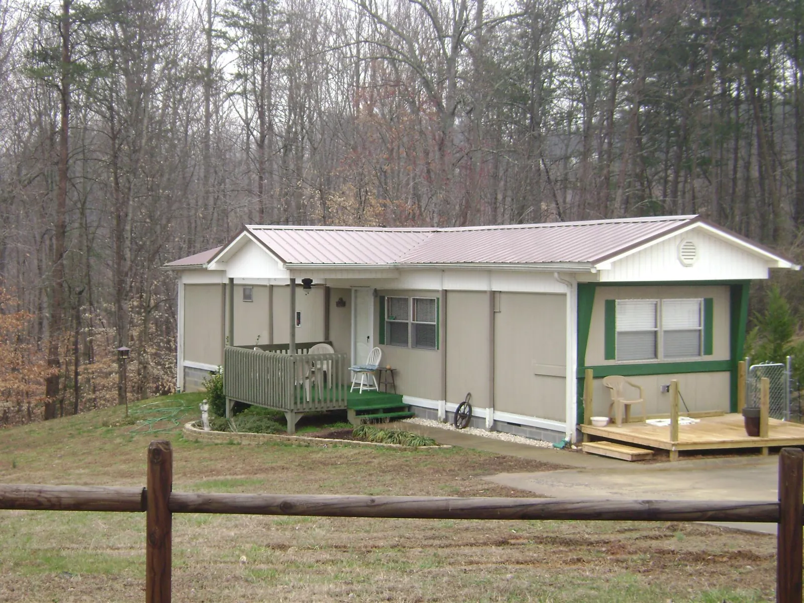 Mauve metal roof on a manufactured home with a new front deck in Terreton